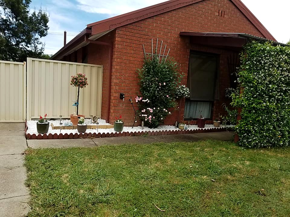 Well-maintained front lawn and garden beds at a Canberra home