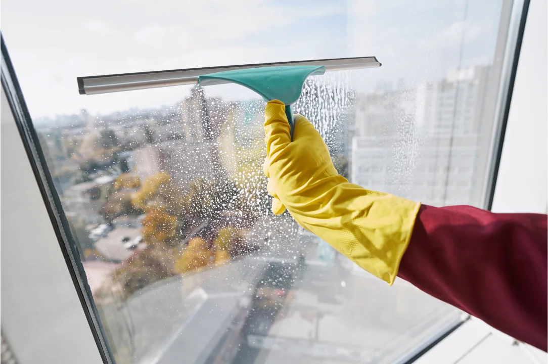 Window cleaning with a squeegee on a glass window